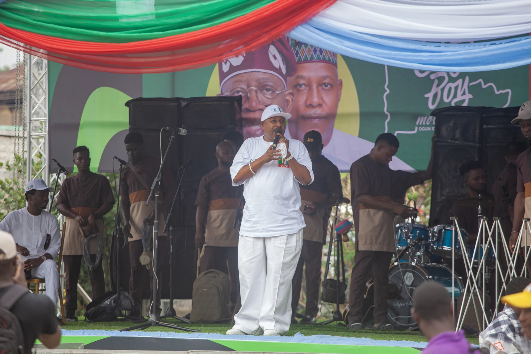 A speaker addressing attendees from the inauguration stage
